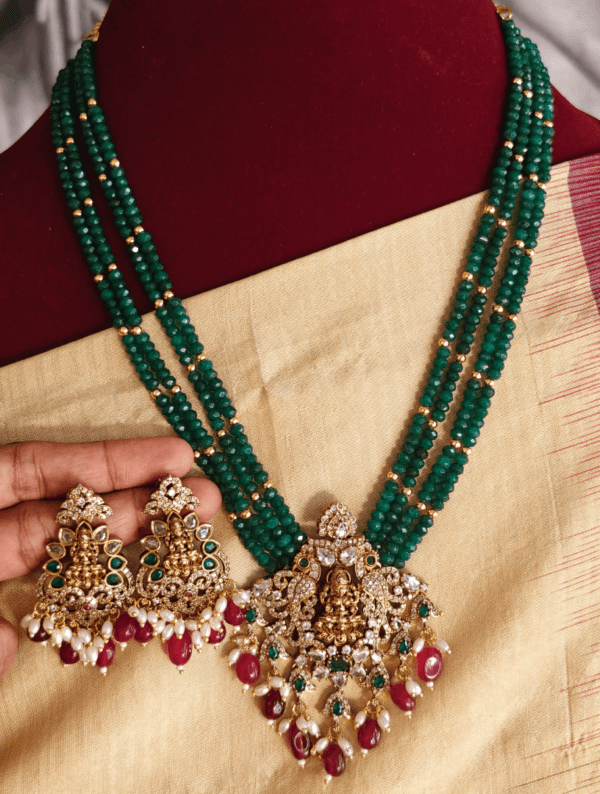 Lakshmi pendant set with four line dark green beads with antique gold balls