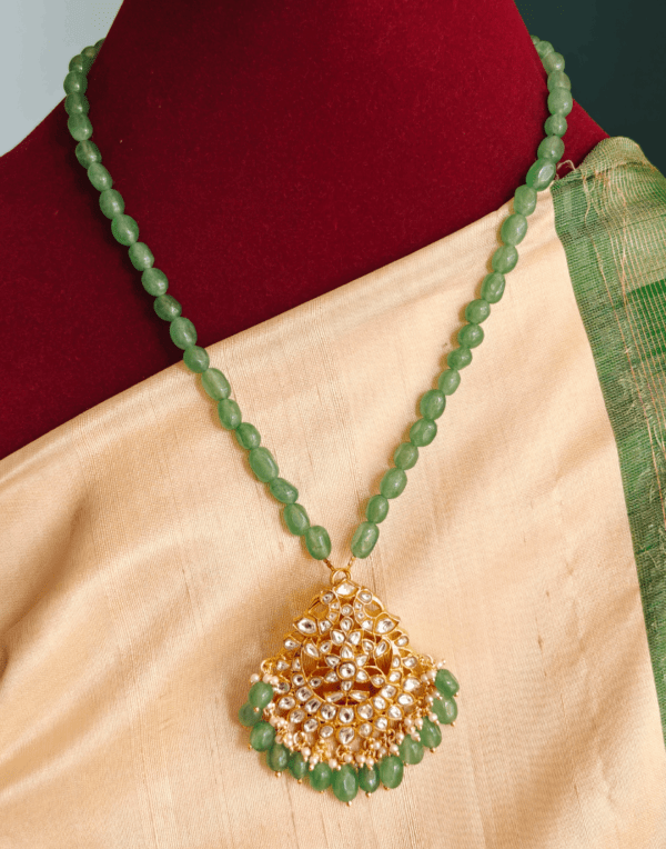 Mossainaite white stone pendant with green beads