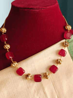 Red flat beads with antique balls