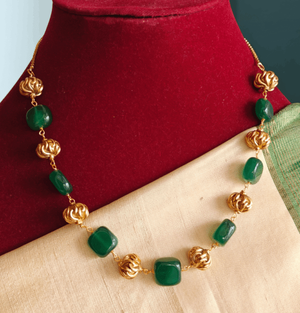 Green flat beads with antique balls