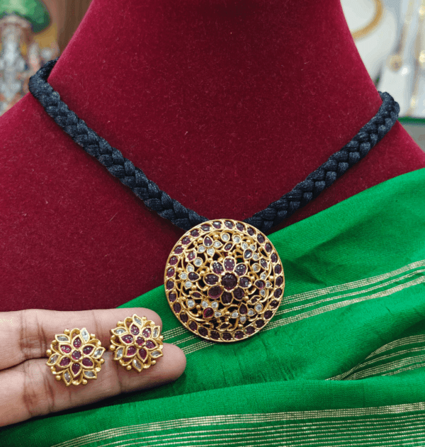 Flower pendant set with braided black rope