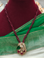 Peacock with garnet beads