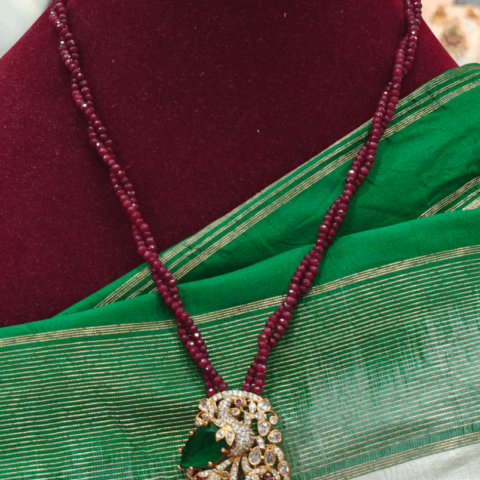 Peacock with garnet beads