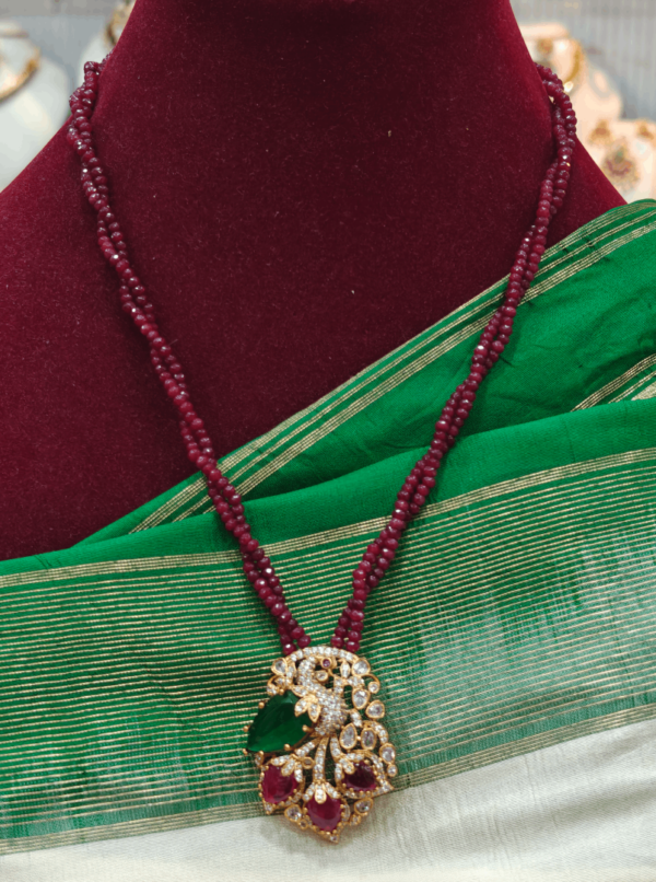 Peacock with garnet beads