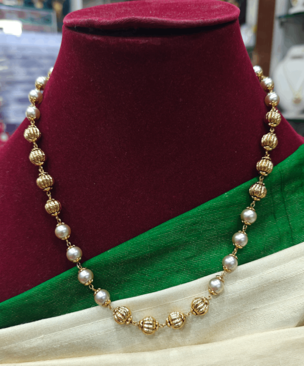 Pearl mala with gold balls