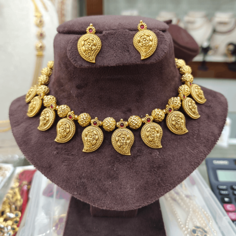 Mango with gold ball`s choker